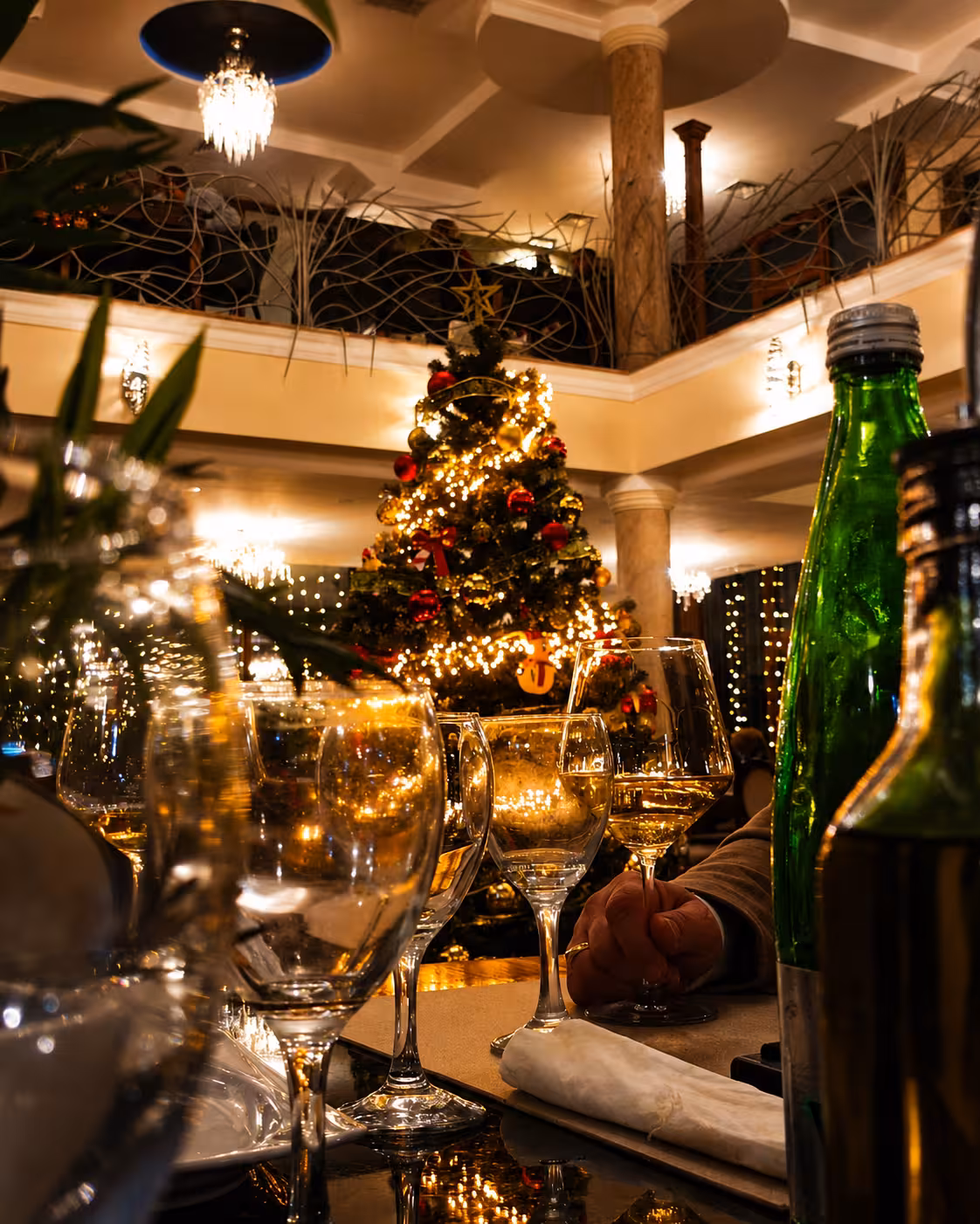 Festive restaurant with Christmas tree and wine
